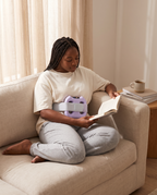 Reading on the sofa with the Unwind ring on the lower belly