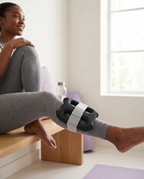 Black Unwind ring strapped to the calf after a workout