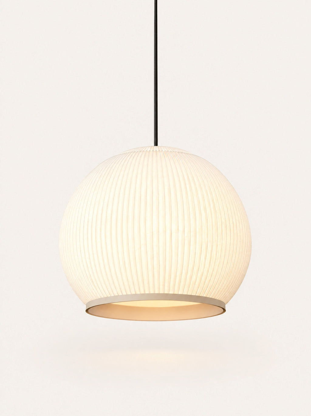 Bloom Pleated Pendant switched on, studio photo on a warm white background