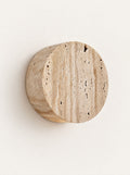 Coin Travertine Wall Light, studio photo on a warm white background
