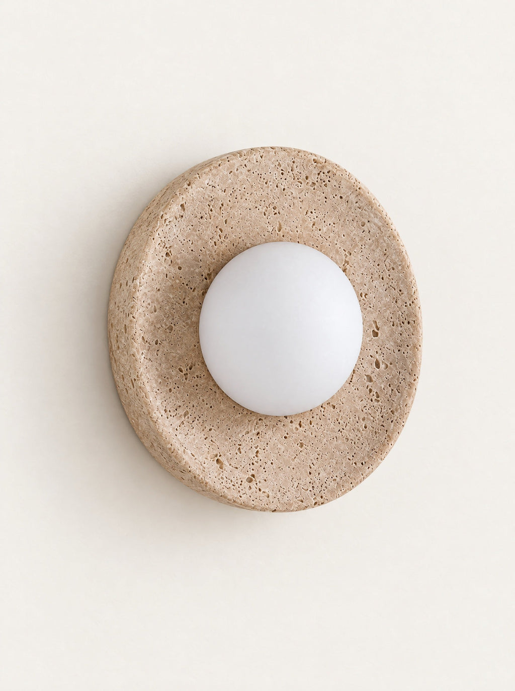 Eclipse Travertine & Opal Sconce, studio photo on a warm white background