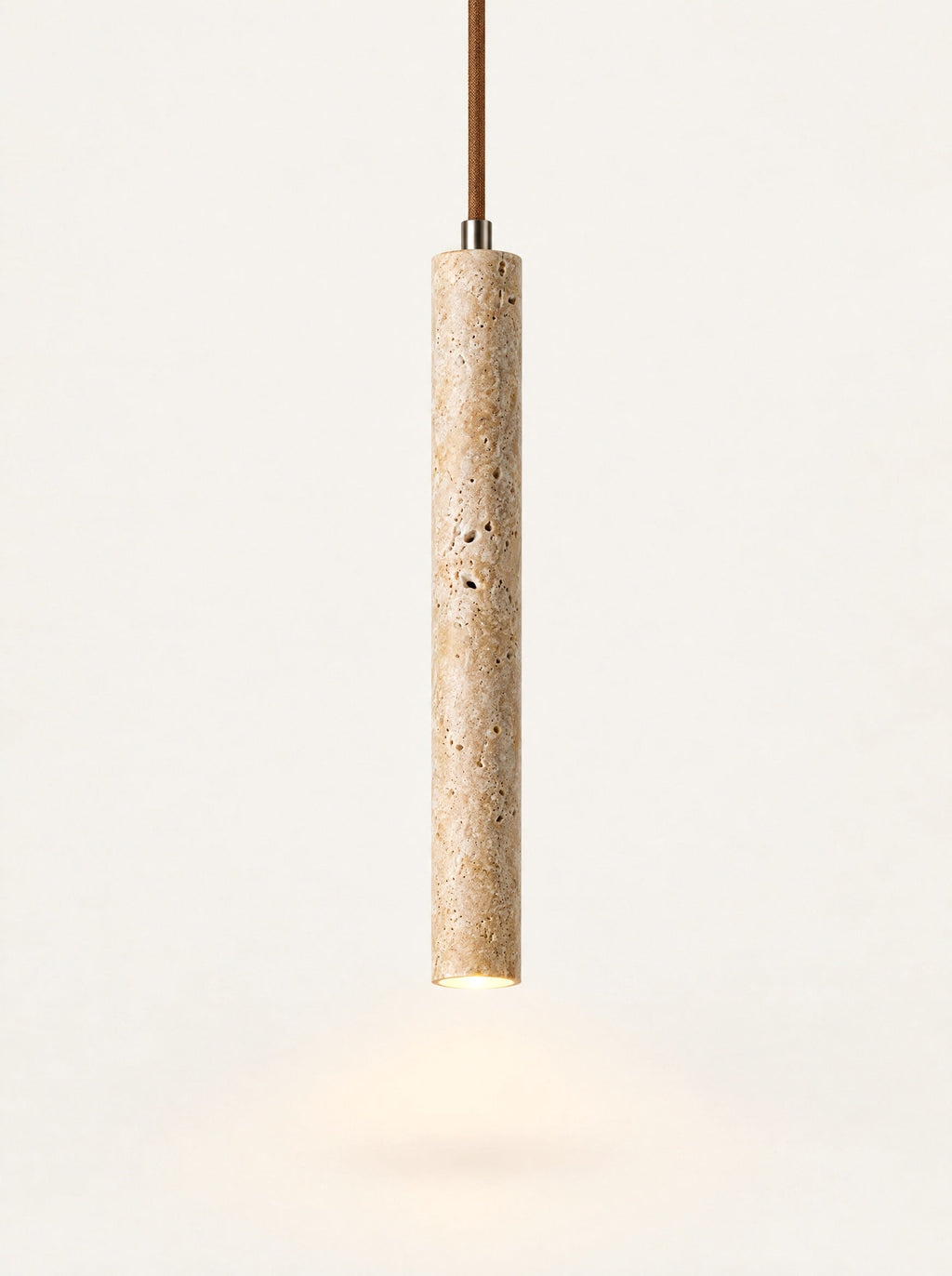 Flute Travertine Tube Pendant switched on, studio photo on a warm white background