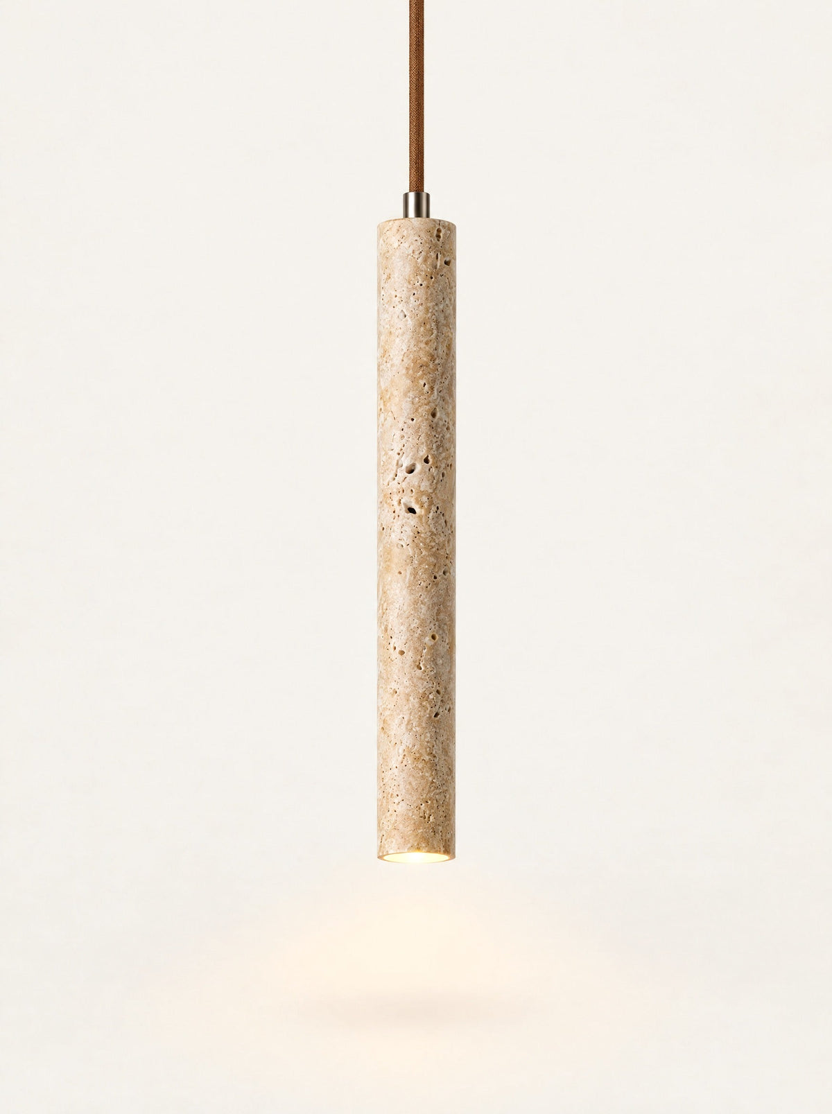 Flute Travertine Tube Pendant switched on, studio photo on a warm white background