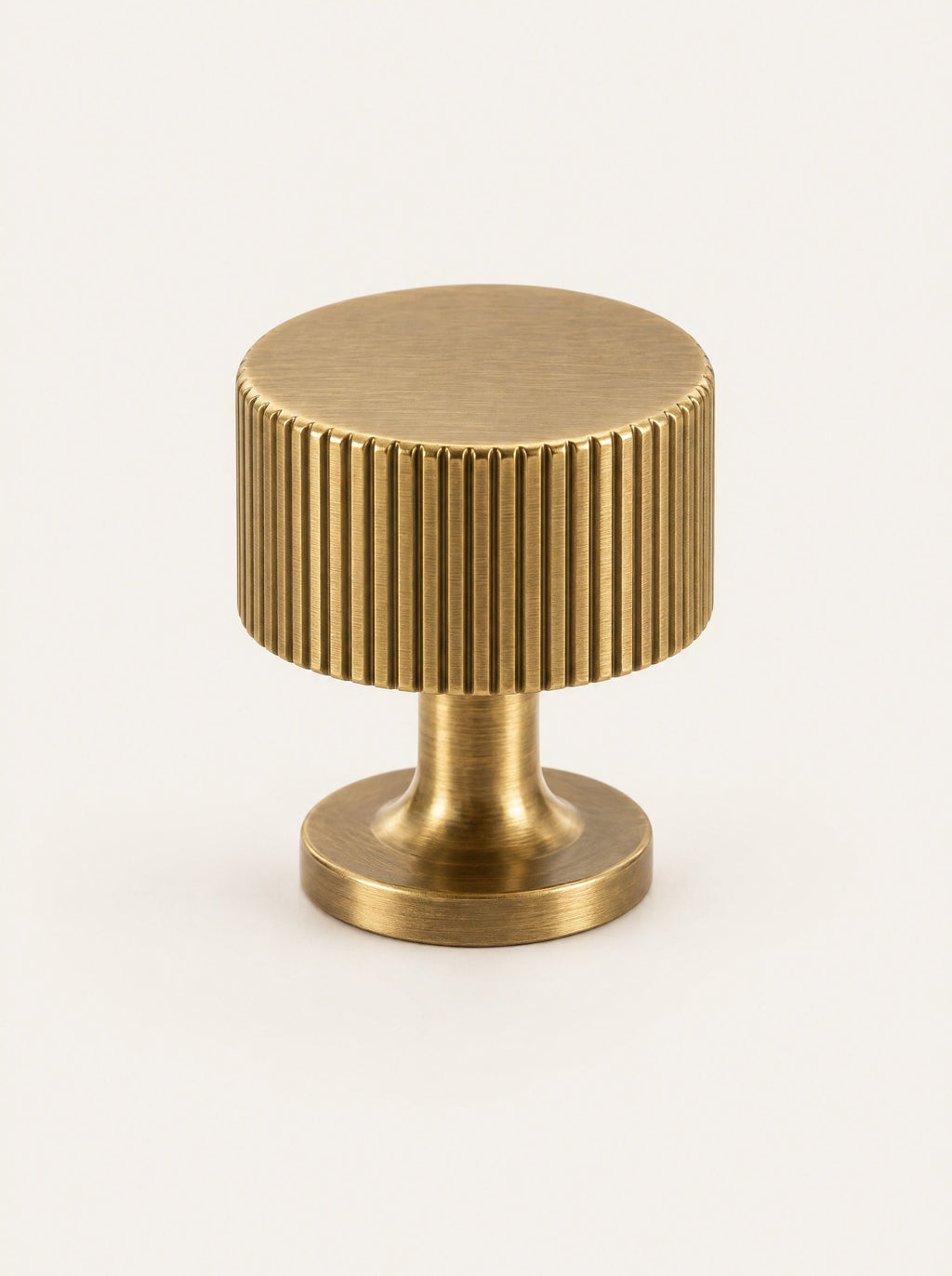 Groove Brass Cabinet Knob, studio photo on a warm white background