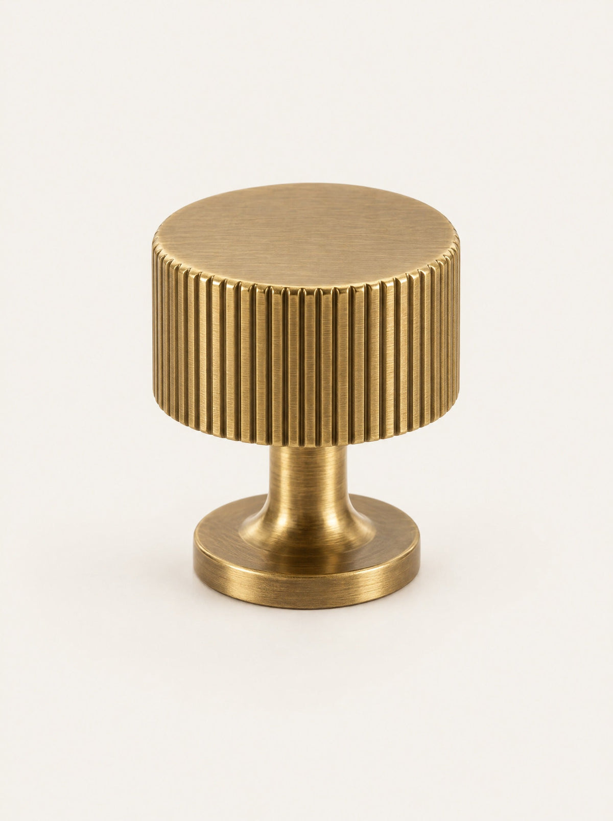 Groove Brass Cabinet Knob, studio photo on a warm white background