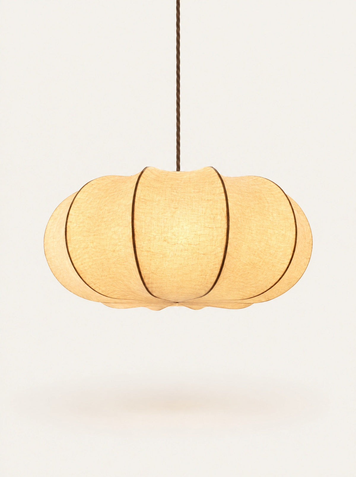 Haze Pleated Pendant switched on, studio photo on a warm white background