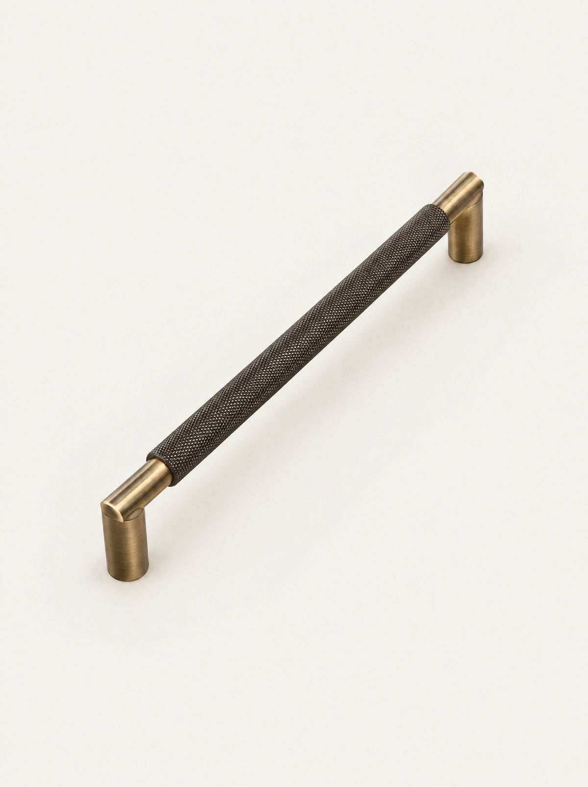 Knurl Brass Door Pull, studio photo on a warm white background