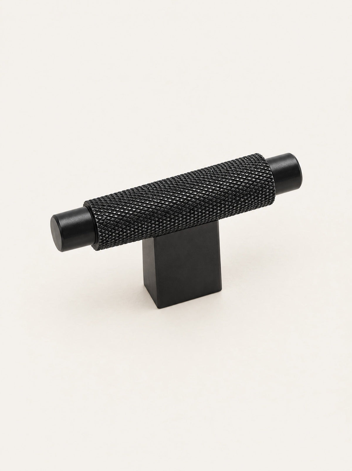 Knurl Brass T-Bar Handle, studio photo on a warm white background