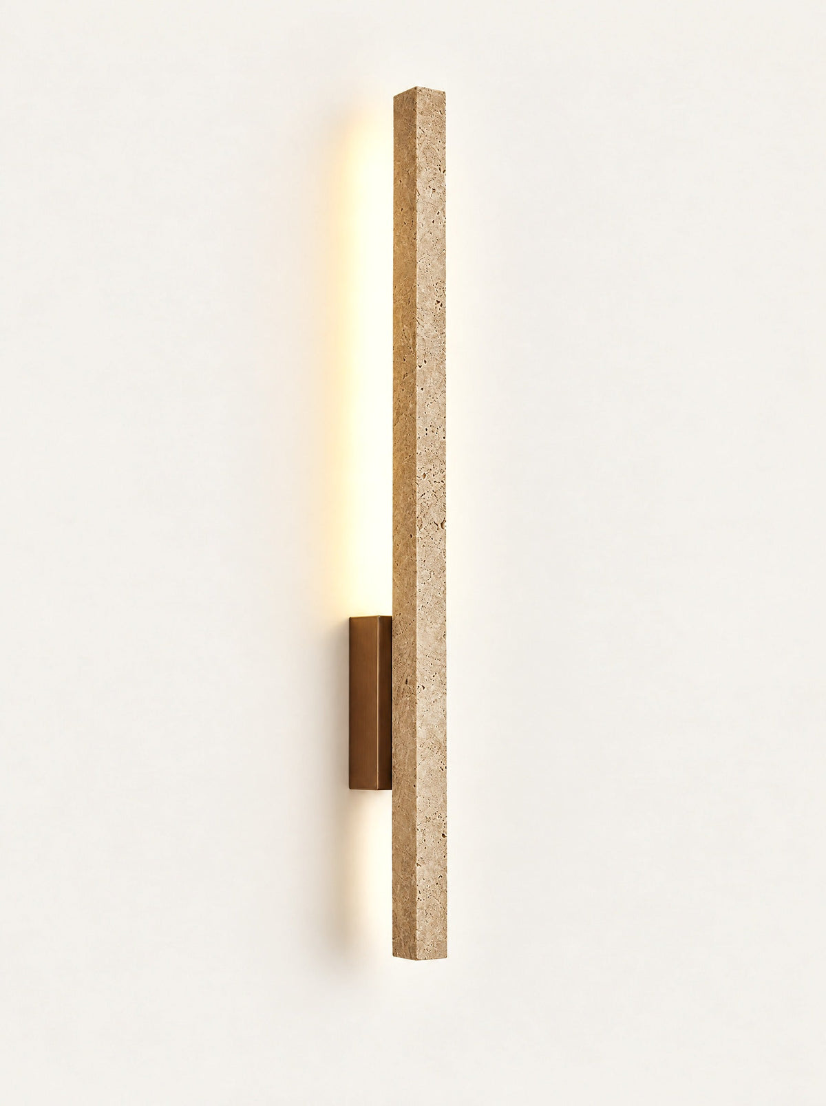 Line Travertine Linear Sconce switched on, studio photo on a warm white background