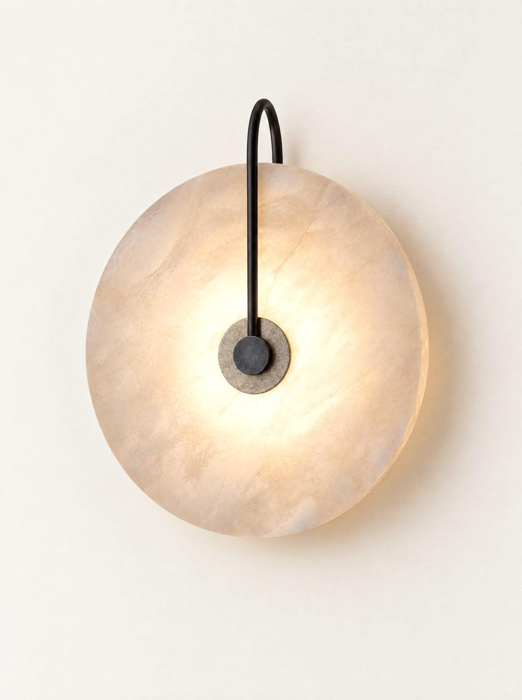 Moonstone Marble Sconce switched on, studio photo on a warm white background