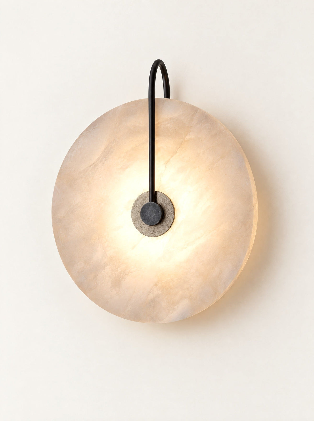 Moonstone Marble Sconce switched on, studio photo on a warm white background