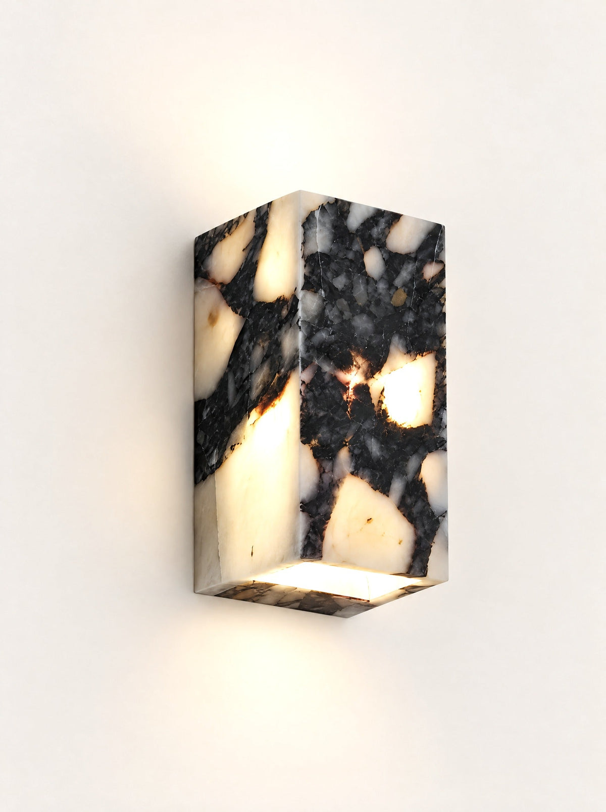 Nero Marble Cube Wall Light switched on, studio photo on a warm white background