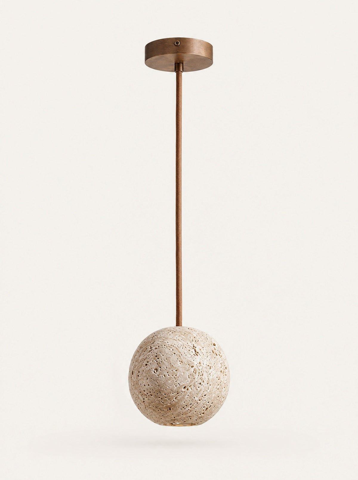 Orbit Travertine Ball Pendant, studio photo on a warm white background