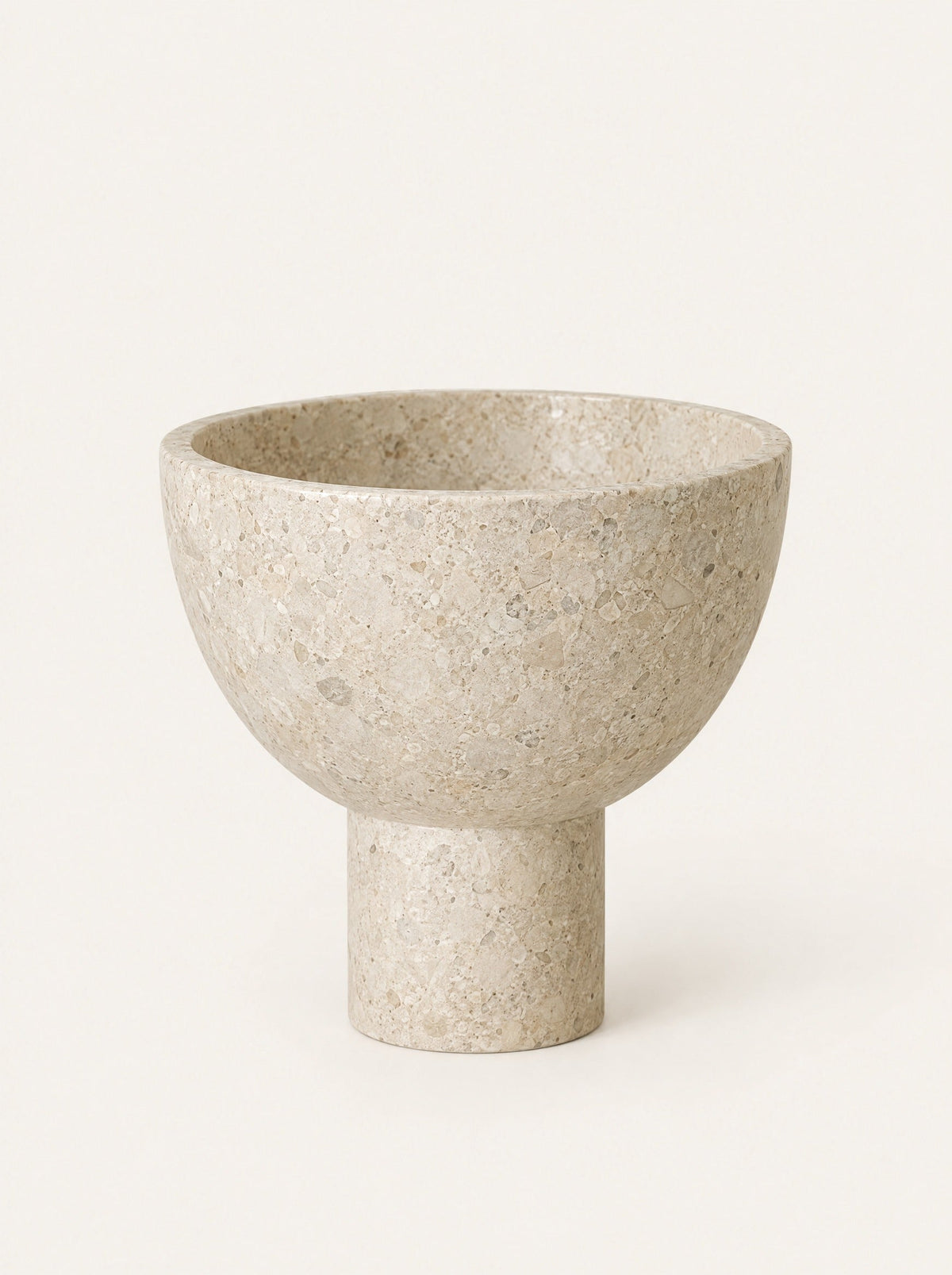 Plinth Stone Pedestal Bowl, close-up studio photo on a warm white background