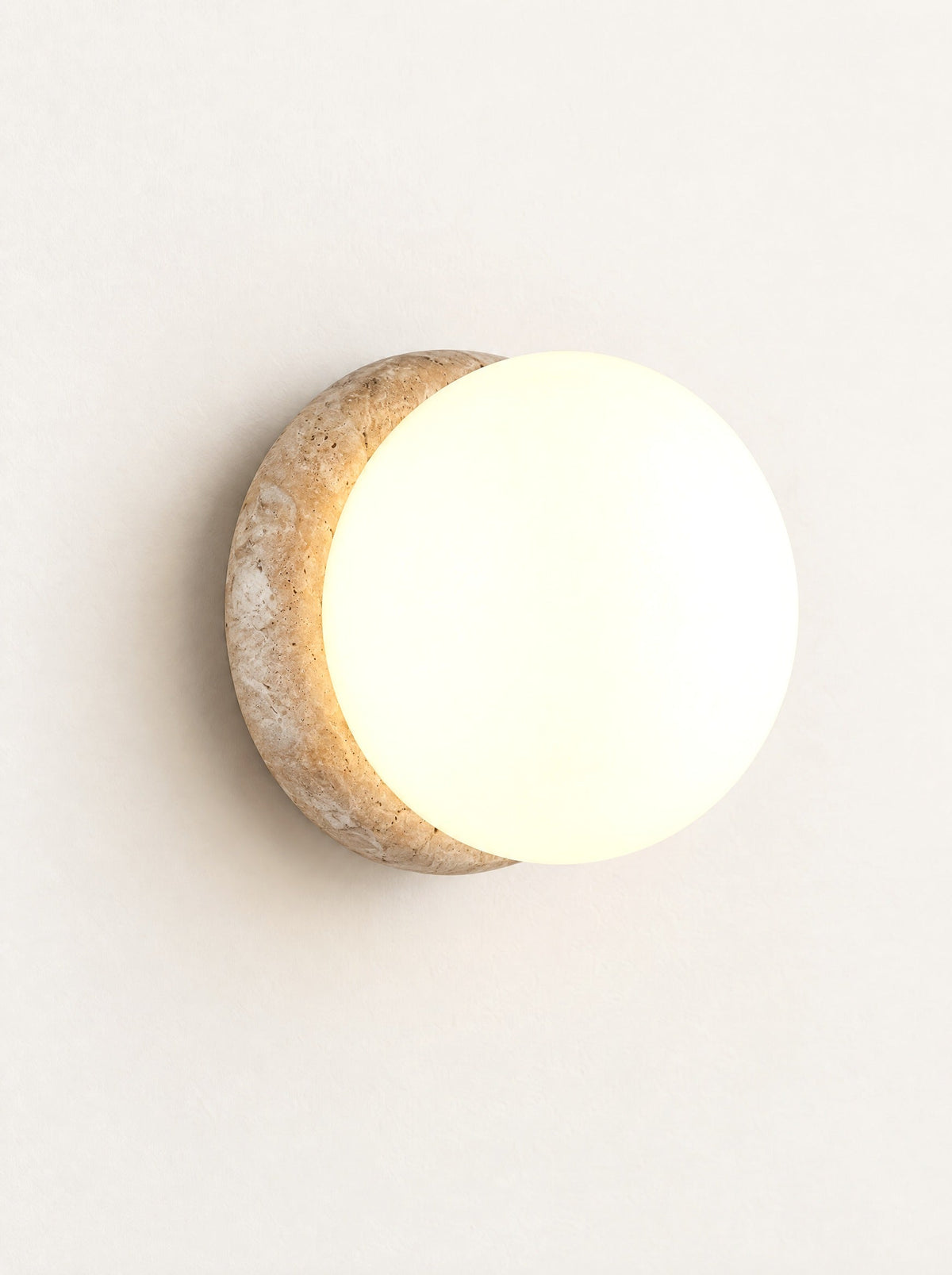 Porthole Stone & Glass Wall Light switched on, studio photo on a warm white background
