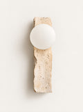 Quarry Travertine Globe Sconce, studio photo on a warm white background