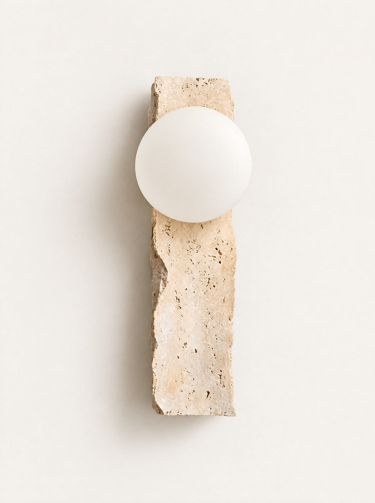 Quarry Travertine Globe Sconce, studio photo on a warm white background
