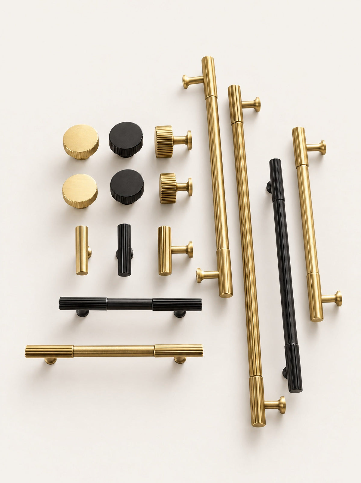 Rib Brass Knob & Pull Collection, close-up studio photo on a warm white background