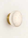 Selene Marble Disc Sconce, studio photo on a warm white background