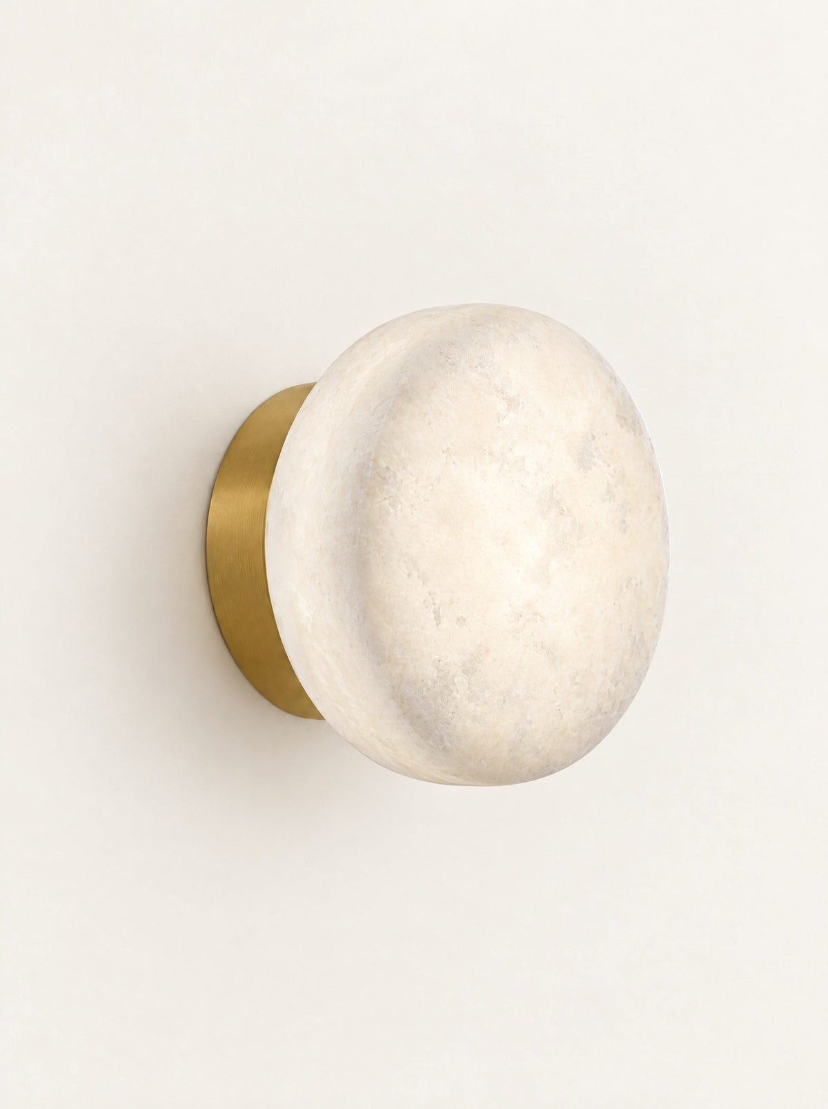 Selene Marble Disc Sconce, studio photo on a warm white background