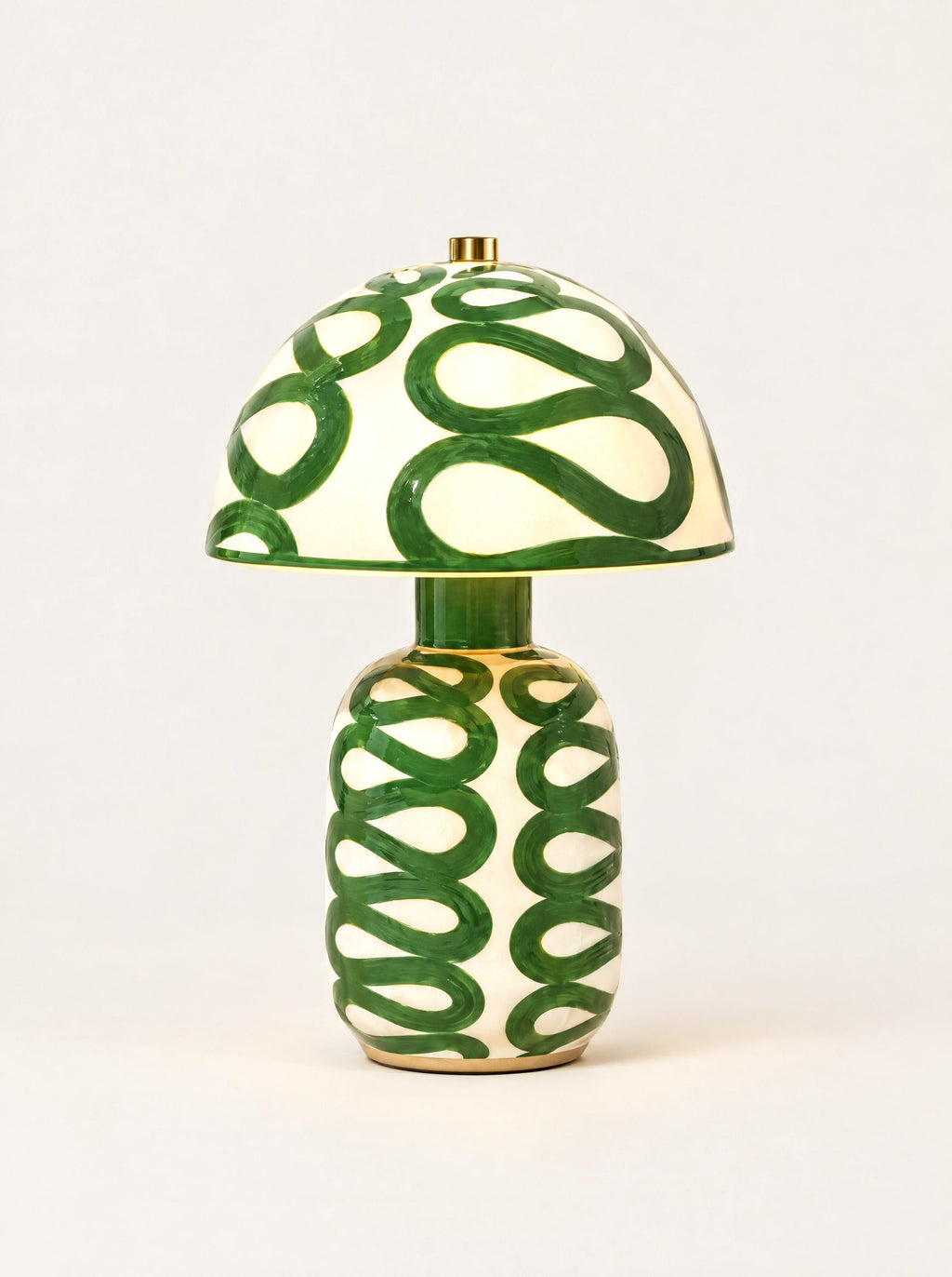 Swirl Ceramic Table Lamp switched on, studio photo on a warm white background