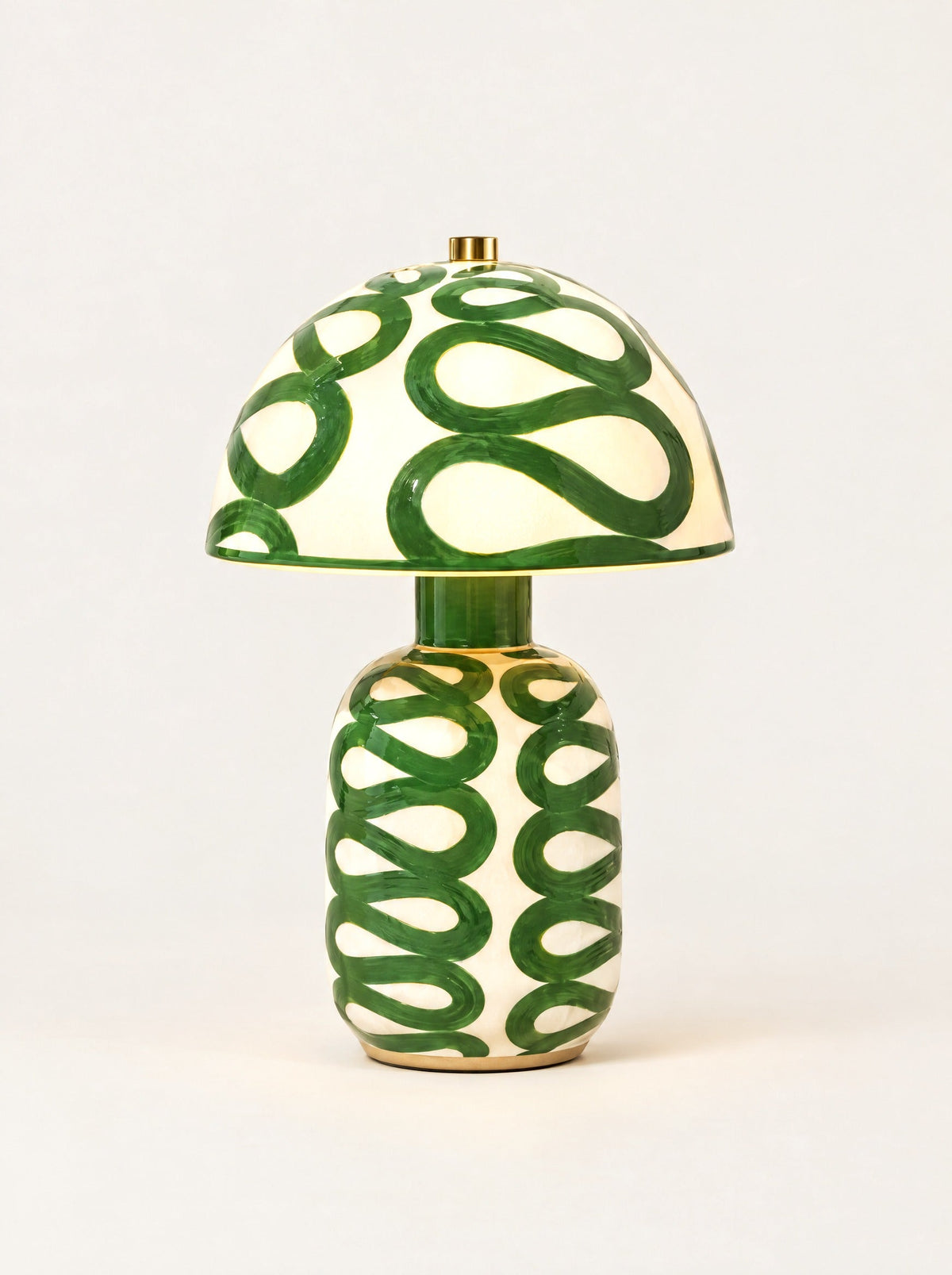 Swirl Ceramic Table Lamp switched on, studio photo on a warm white background