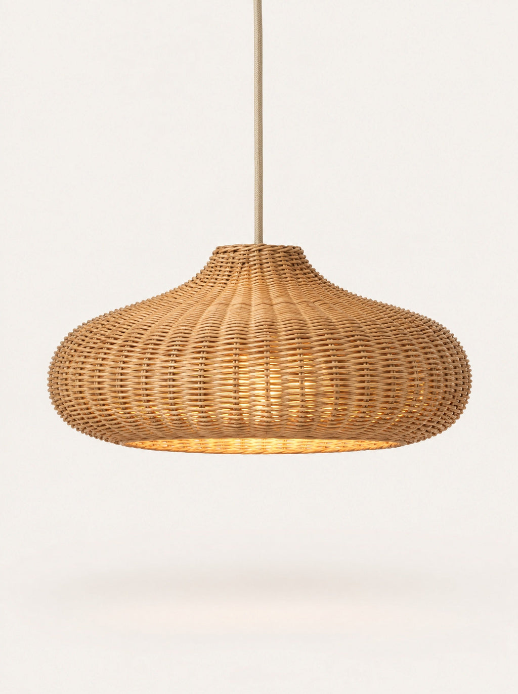 Weave Rattan Pendant switched on, studio photo on a warm white background